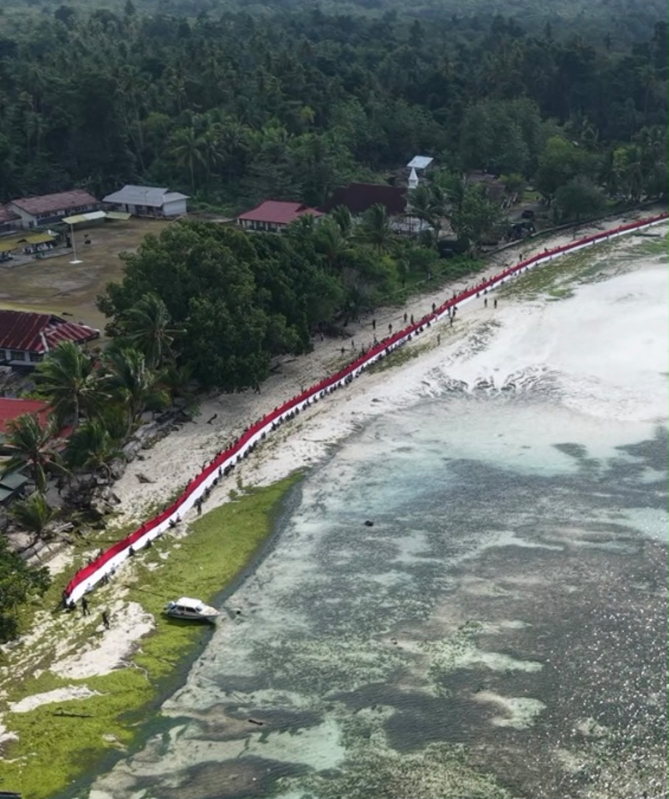 Kodam XV/Pattimura Bentangkan Bendera Merah Putih 500 Meter di Pesisir Aboru, Maluku Tengah